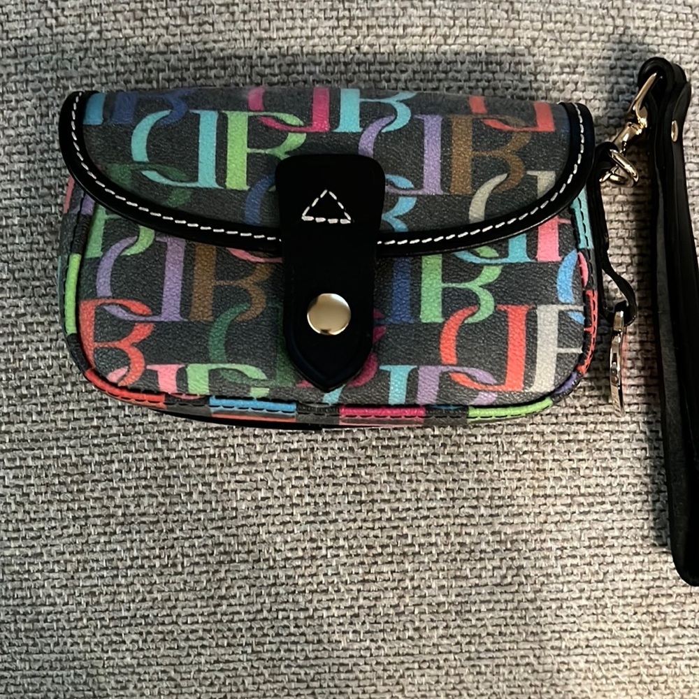 Dooney & Bourke multi color flap wristlet. Black leather trim and canvas.